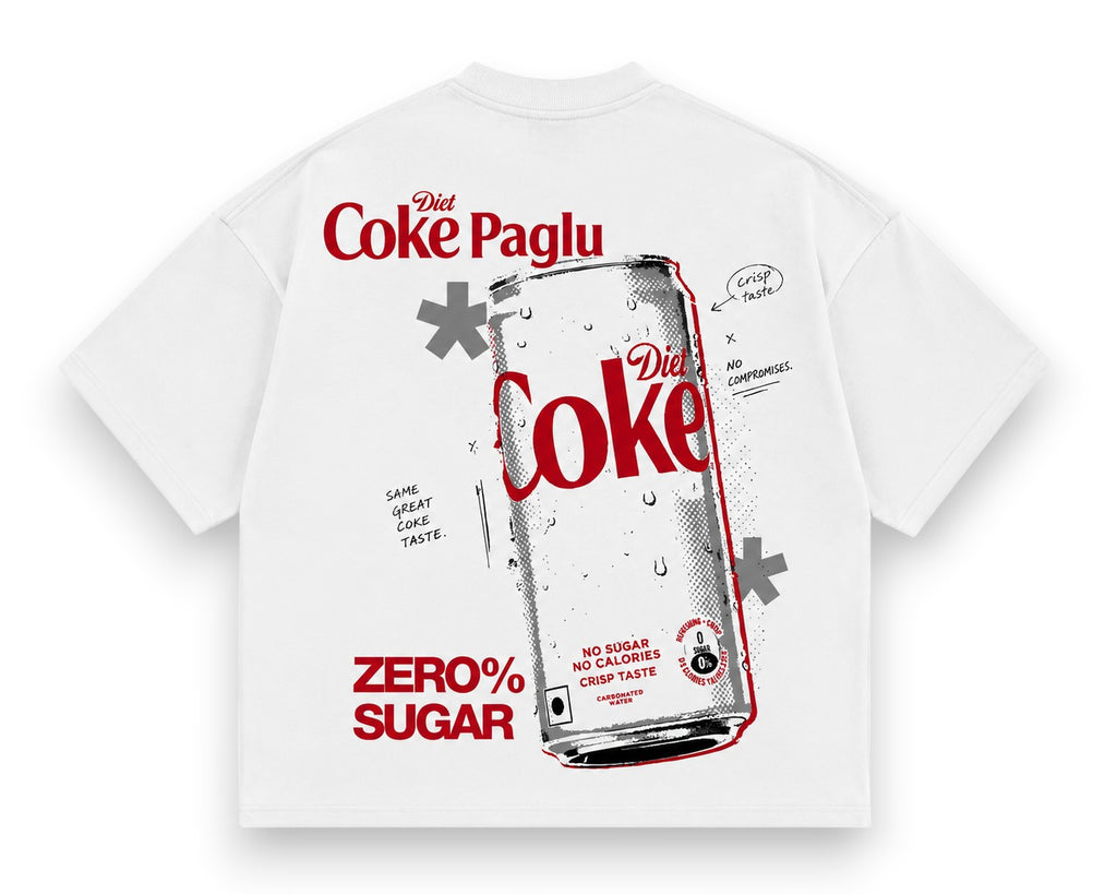 A white short-sleeve t-shirt with a large graphic print on the front. The design features a silver can of Diet Coke with red lettering, surrounded by red text reading 'Diet Coke Paglu' and 'ZERO% SUGAR', along with small black doodle-style notes.